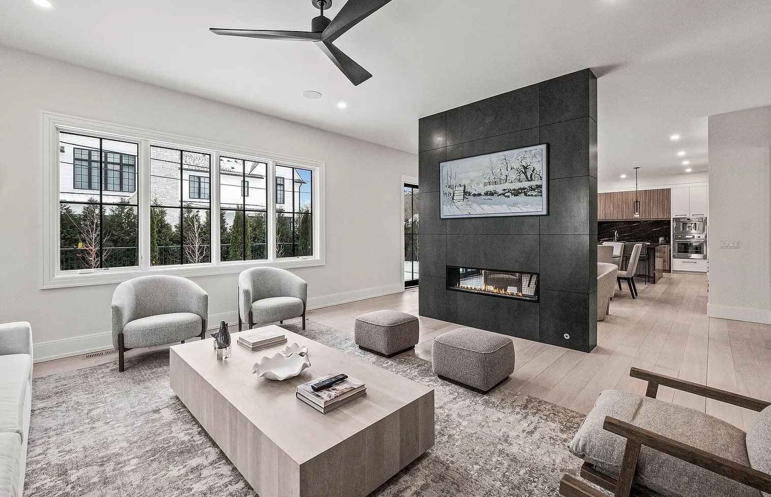 a living room filled with furniture and a large window