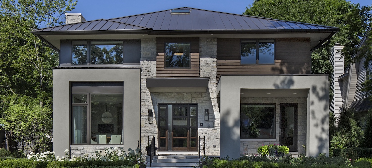 a house with bushes in front of a building