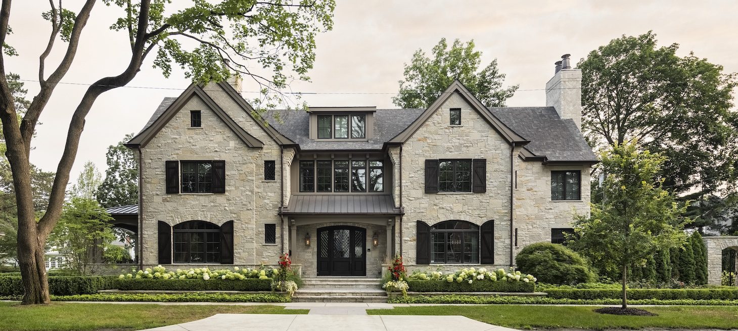 a small clock tower in front of a house
