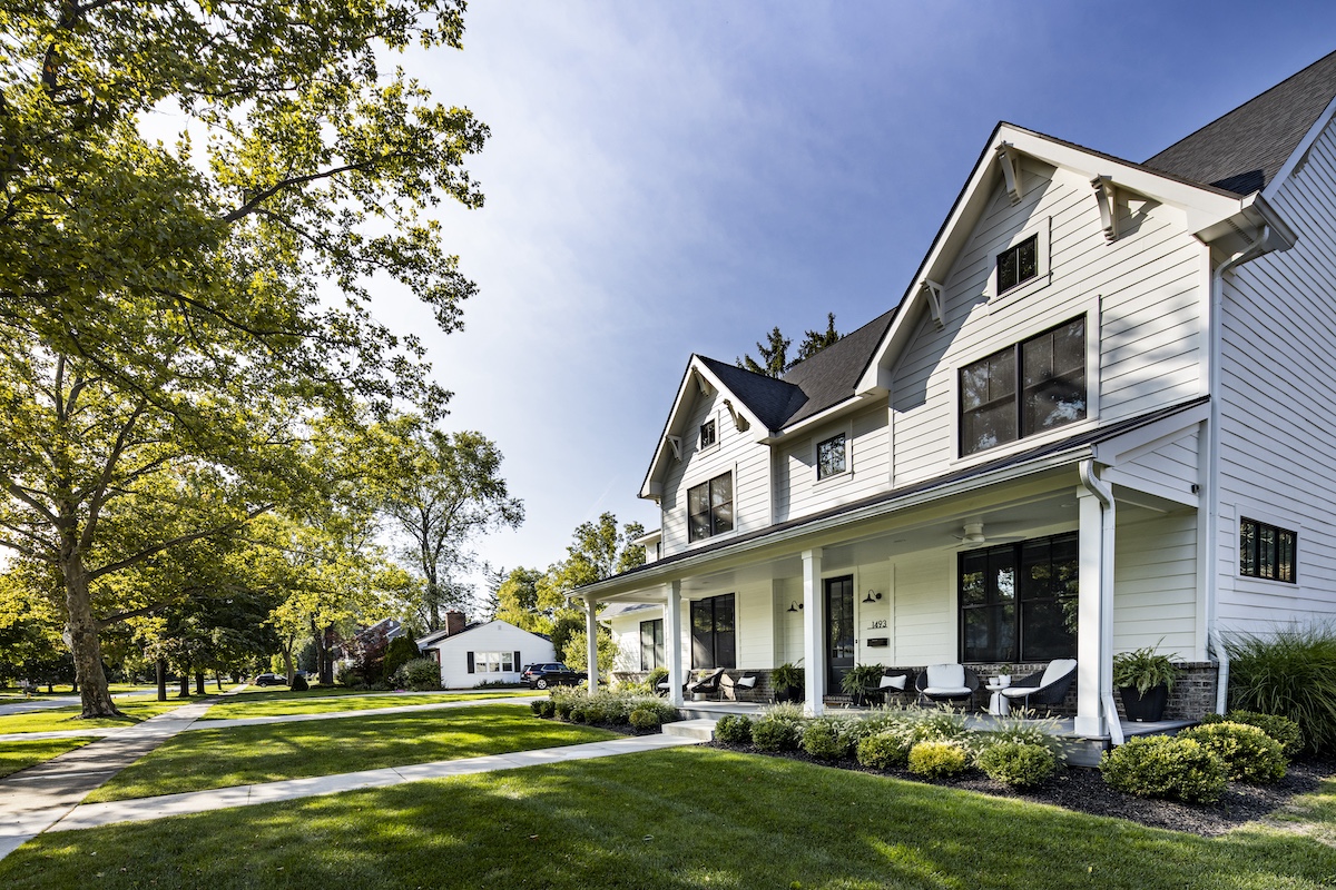 a large brick building with grass in front of a house
