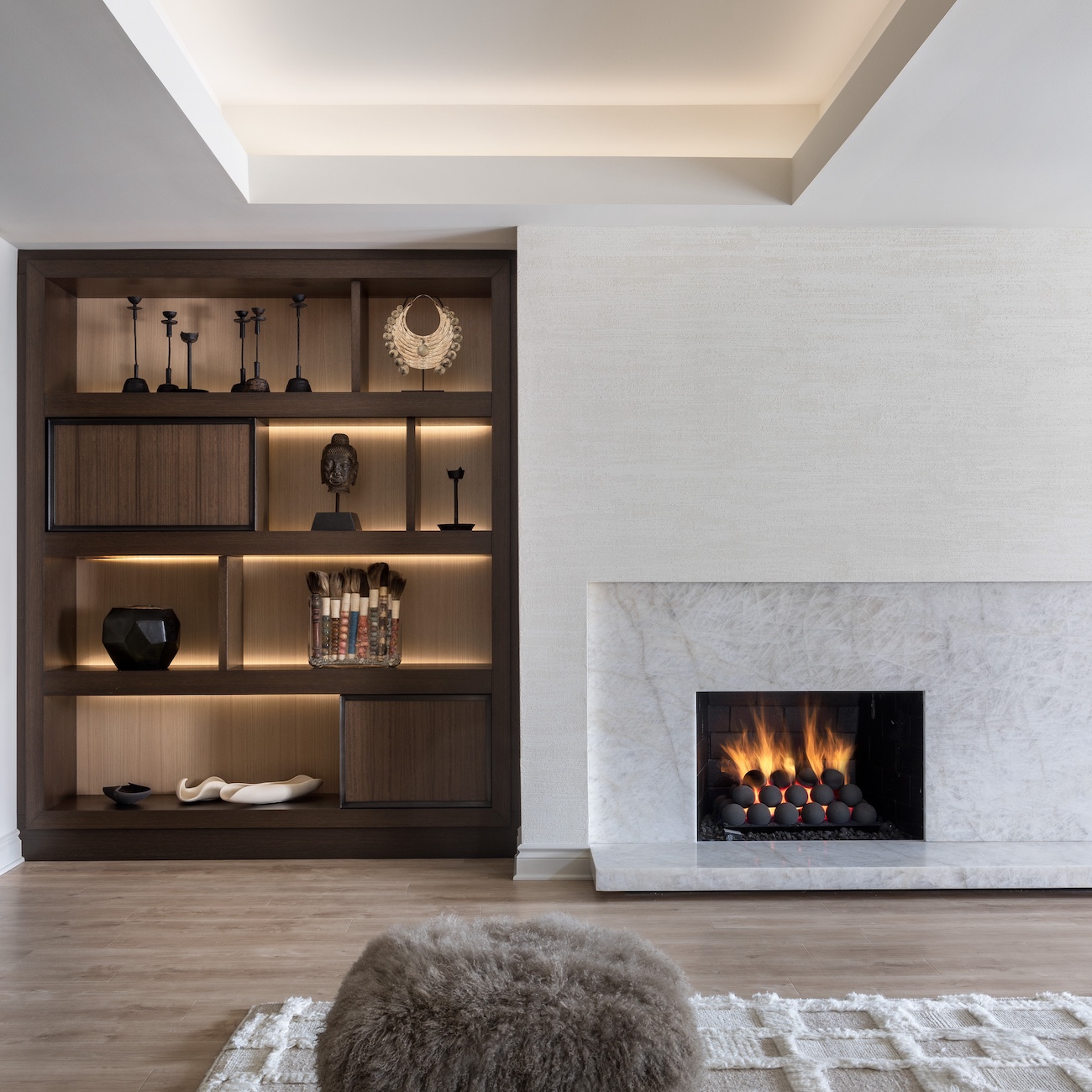 a fire place sitting in a living room filled with furniture and a fireplace