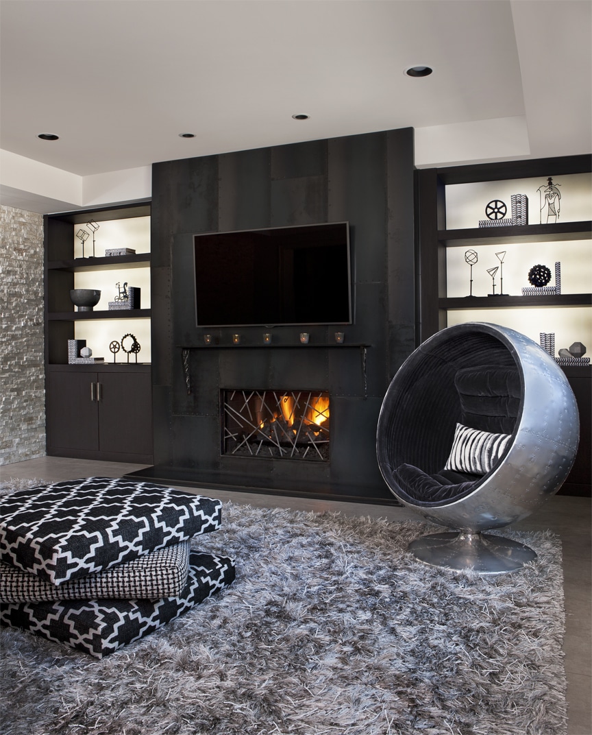 a giraffe standing next to a fireplace