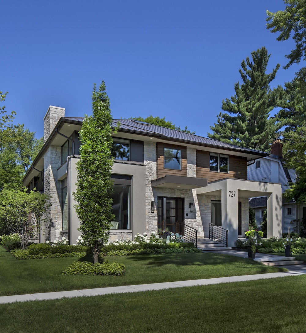 a small clock tower in front of a house